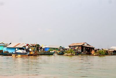 Boats in sea against clear sky