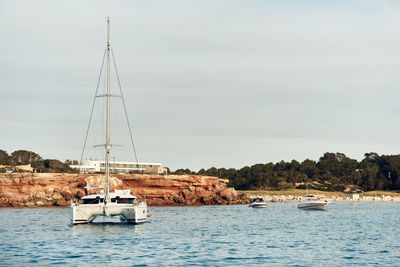 Sailboats on sea against sky