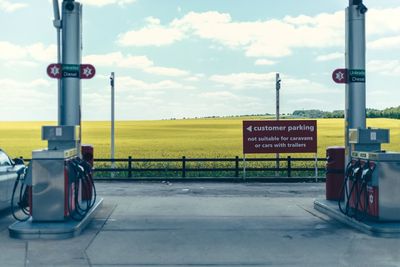 Road sign against sky