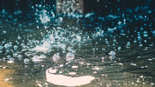 Close-up of raindrops on swimming pool