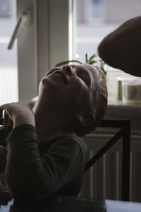 Close-up of smiling boy at home