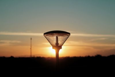 Low angle view of silhouette street light against sky during sunset
