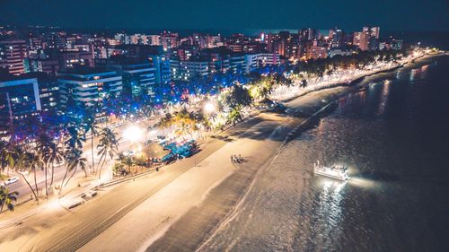 High angle view of illuminated city buildings at night