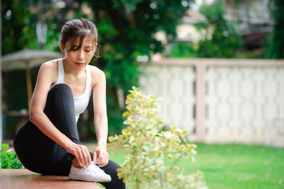 Young woman sitting outdoors