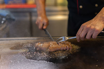 Midsection of man preparing food