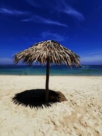 Lifeguard hut on beach against sky