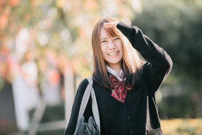 Portrait of a smiling young woman outdoors