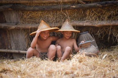 Boys sitting on hay