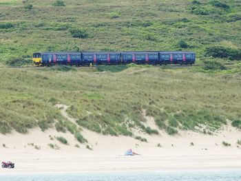 Train on shore by sea