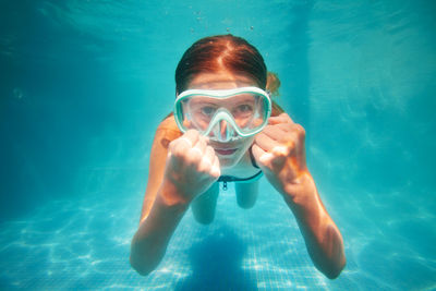 Portrait of woman swimming in sea