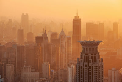 Cityscape against sky during sunset