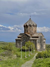 Built structure on field against sky