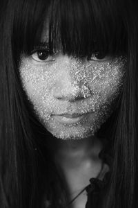 Close-up portrait of young woman with bangs