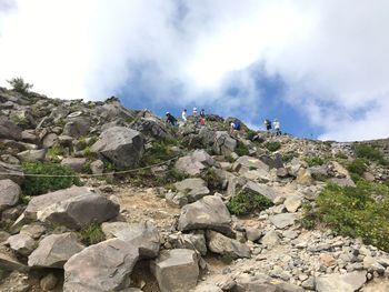 Low angle view of mountain against cloudy sky