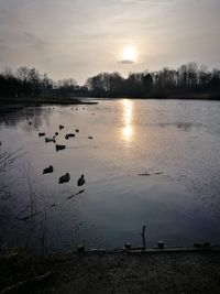 Scenic view of lake against sky during sunset