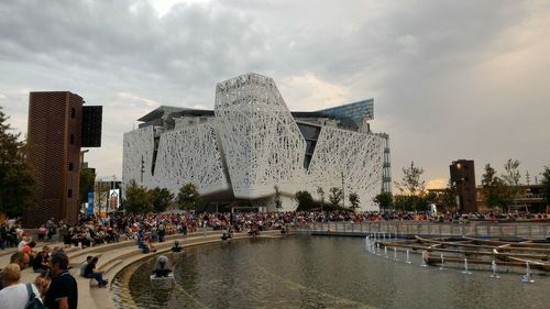 People walking on promenade in city