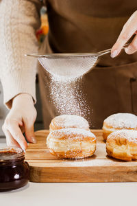 Midsection of woman having food on table