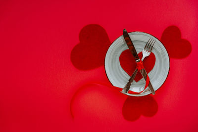 Close-up of clock against red background