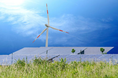 Windmill on field against sky