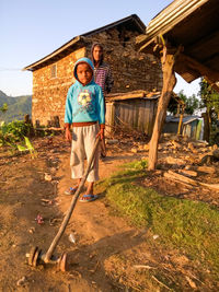 Portrait of woman standing against built structure
