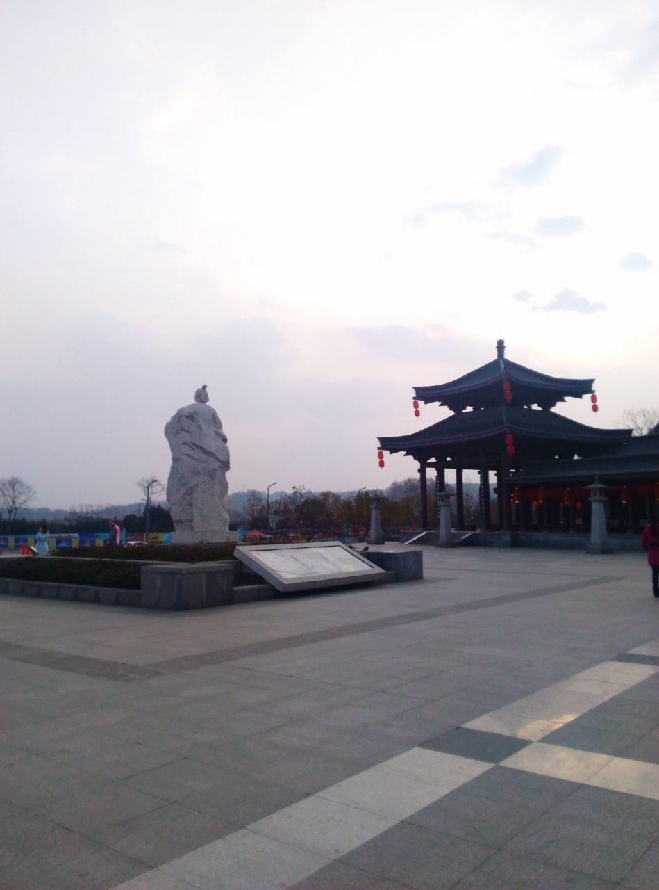 sky, cloud - sky, built structure, architecture, water, religion, spirituality, temple - building, building exterior, place of worship, cloudy, cloud, sea, outdoors, sculpture, incidental people, tranquility, travel destinations, nature