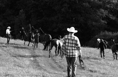 People riding horses on field