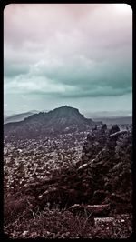 Scenic view of mountains against cloudy sky