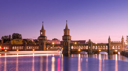 View of illuminated bridge in city against sky