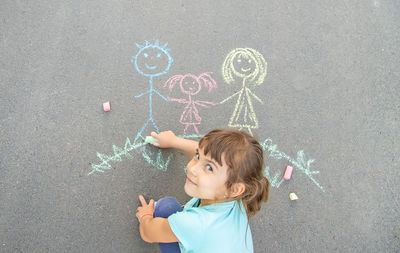 Girl drawing on road