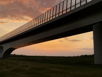 Low angle view of bridge against sky during sunset