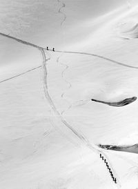 High angle view of people skiing on snow covered land