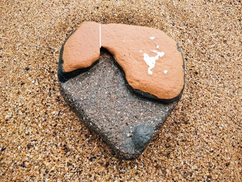 Close-up of heart shape on sand