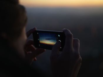 Woman photographing through smart phone