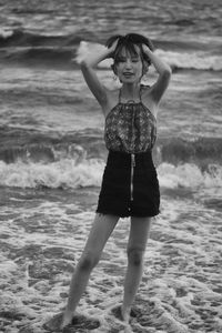 Full length of woman standing at beach