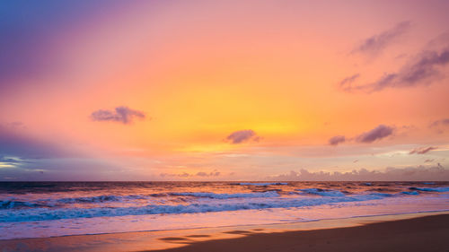 Scenic view of beach against sky during sunset