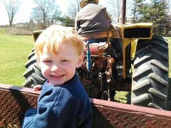 Boy looking away while standing on white background