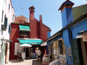 People walking on street amidst buildings in city