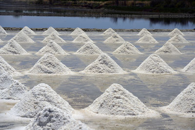 Salt heaps with reflection on water