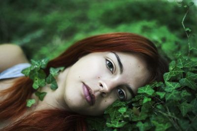 Portrait of young woman by plants