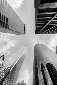 Low angle view of modern building against cloudy sky
