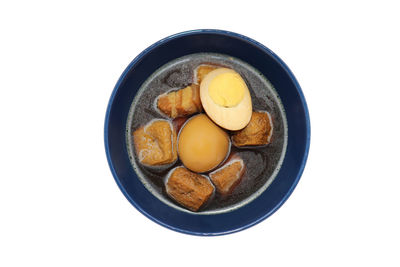 High angle view of eggs in bowl against white background