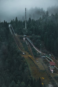 Skijumping arena in the forest, schwarzwald, germany. old sports building surrounded by dark trees.
