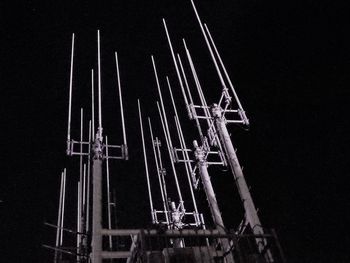 Low angle view of windmill against clear sky at night