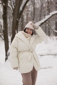 Low section of woman sitting on railing