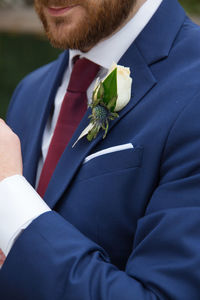 Midsection of man holding bouquet