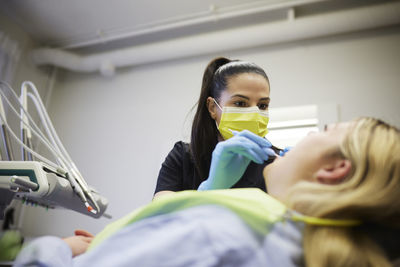 Female dentist with patient in office