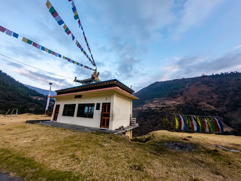 House on mountain against sky