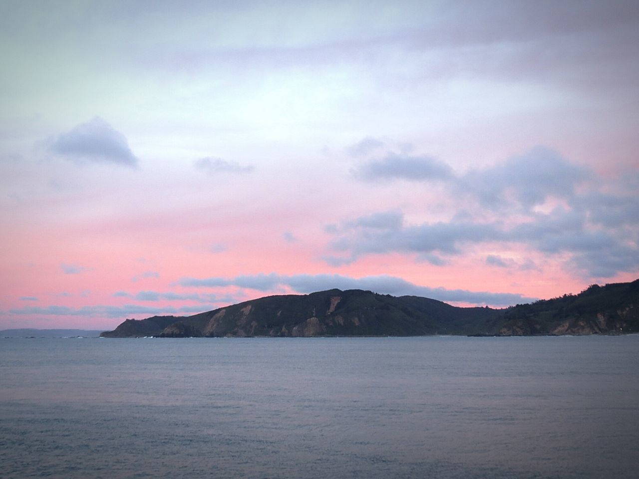 water, scenics, tranquil scene, sea, waterfront, tranquility, mountain, beauty in nature, sky, nature, cloud - sky, idyllic, sunset, mountain range, cloud, rippled, cloudy, remote, non-urban scene, outdoors