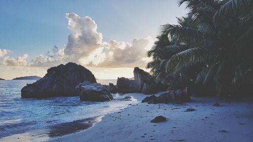 Panoramic view of rocks on beach against sky