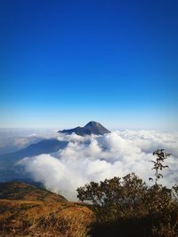 Scenic view of mountains against blue sky